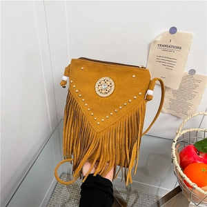 Bohemian mustard yellow crossbody bag with long tassels and gold rivet details