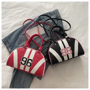 Detail view of colorful bowling bags with number print and metal feet on denim