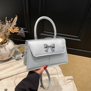 Silberne Pailletten-Handtasche mit Metallschleife und rundem Griff für modische Damen