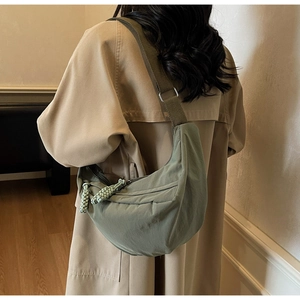 Detail of Morandi green nylon crescent bag showing fabric texture and shoulder strap
