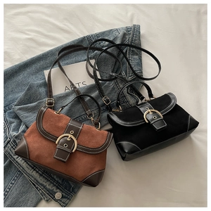 Detail of vintage flap crossbody bags with gold buckle and white contrast stitching detail