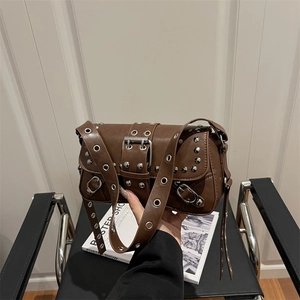 Deep brown punk style shoulder bag with silver rivets and metallic eyelet straps