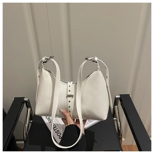 Macro view of white matte leather shoulder bag with silver belt buckle detail