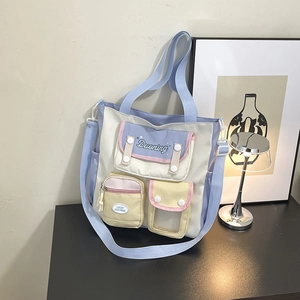 Chic multi-pocket nylon shoulder bag in blue and white with adjustable strap