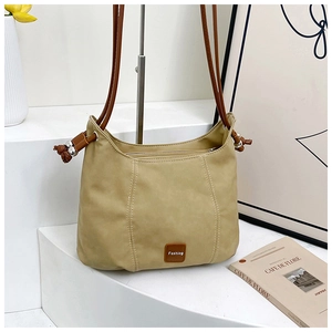 Close-up of minimalist beige shoulder bag with leather accents and Fashion logo detail