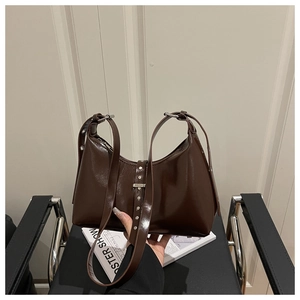 Detail of dark brown hobo bag with glossy finish and silver rivet belt decorations
