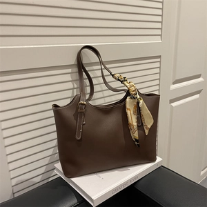Dark brown minimalist tote bag with contrast stitching and elegant silk scarf detail