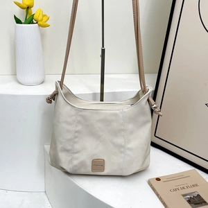 Minimalist cream shoulder bag with leather Fashion tag and brown drawstring straps