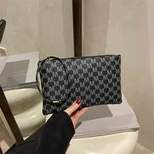 Chic women's envelope clutch bag with black and grey monogram print and wrist strap