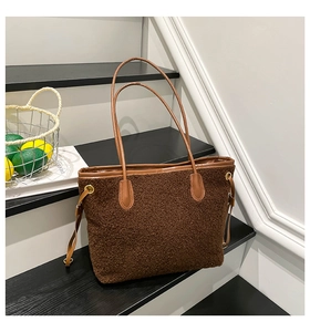 Detail view of large brown plush tote bag with lamb wool texture and contrast PU trim