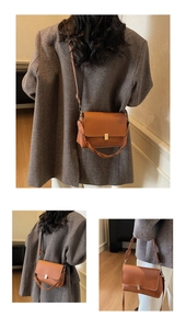 Detail of brown matte leather crossbody bag with gold buckle and slim shoulder strap