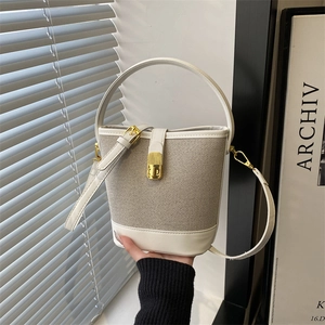 Minimalist beige bucket bag with mesh texture and gold hardware for women