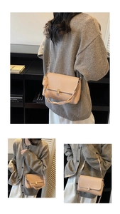 Detail of apricot PU leather handbag featuring a golden clasp and twisted texture handle