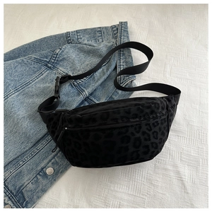 Detail of leopard print waist bag with textured fabric, zipper closure and nylon strap