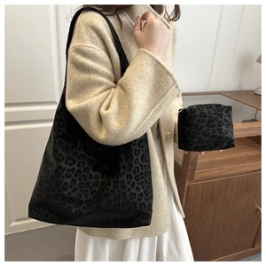 Close-up of leopard print tote bag and matching pouch with textured matte finish