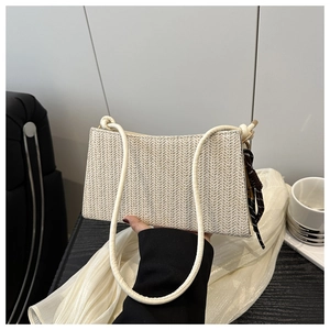Detailed macro view of beige chevron woven tote bag with nautical knot handle straps