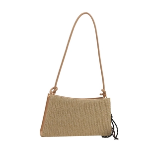Chic beige woven straw shoulder bag with herringbone pattern and polka dot scarf detail