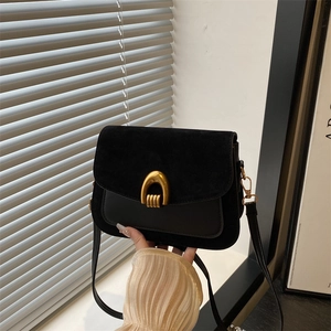 Minimalist black winter crossbody bag with vintage gold U-shaped lock and mixed leather texture