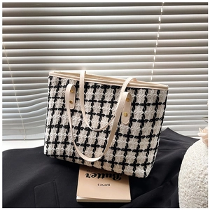 Detail of checkered tweed tote bag with premium cream leather straps and large capacity