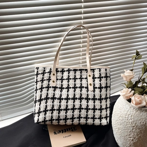 Classic black and white tweed tote bag with slim cream straps and gold rivet accents