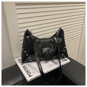 Detailed view of black punk shell bag with silver rivets and metallic square buckle
