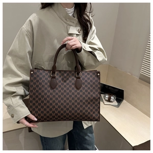 Detailed macro shot of vintage monogram tote bag with brown leather handles and premium stitching