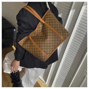 Detail of vintage geometric tote bag with brown leather handles and spacious interior