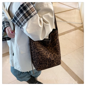 Close-up of leopard print shoulder bag featuring suede texture and spacious tote design