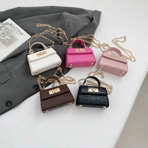Five crocodile-pattern mini handbags in various colors with gold chain straps and turn locks