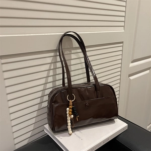 Vintage dark brown faux leather shoulder bag with beaded charm and polished finish