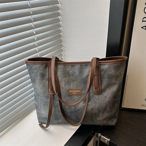 Large gray canvas tote bag with brown leather trim and vintage shoulder straps