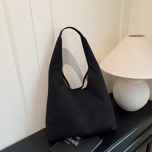Minimalist black matte large capacity shoulder tote bag in a stylish home setting
