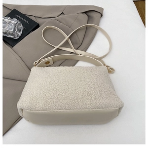 Detail of beige fleece tote bag showing soft faux fur texture and smooth leather strap