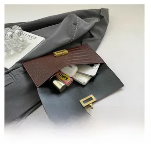 Brown crocodile texture envelope clutch bag detail showing spacious interior capacity