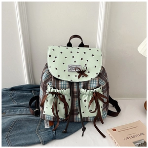 Detail of mint green plaid backpack with decorative brown bow and star pattern
