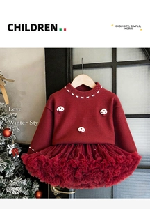 Detail of red knit sweater with 3D mushroom accents and matching layered tutu skirt