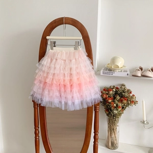 Detail of pink and orange gradient tiered tulle layers on a girl's rainbow tutu skirt