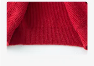 Close-up of red knitted sweater hem showing soft rib texture and high-quality wool fabric