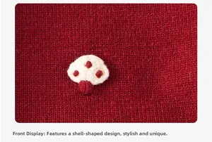 Detailed macro view of the 3D crochet shell-shaped applique on a red knitted sweater