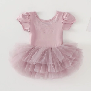 Detailed view of pink girls' ballet leotard with rhinestones and layered tulle tutu skirt