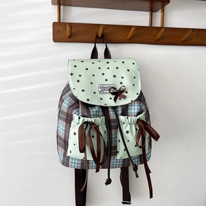 Mint green school backpack with bowknot and plaid pattern on wooden hanger