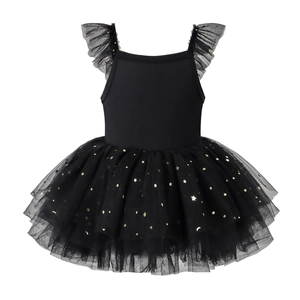 Detail of girls' ballet dress showing layered black mesh with gold star and moon sequins
