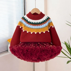 Close-up of girls' festive red sweater with Fair Isle collar and burgundy sequin tutu skirt