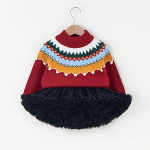 Detail of red festive knit sweater with Fair Isle patterns and black mesh tutu skirt