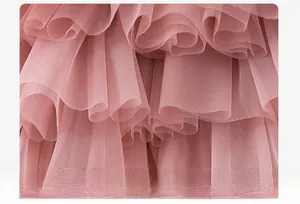 Close-up of soft pink multi-layer mesh fabric with voluminous pleated tulle texture