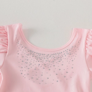 Detail of pink girls ballet leotard with sparkling rhinestones and ruffle sleeve accents