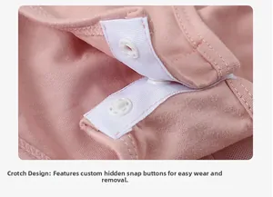 Detailed view of pink cotton romper crotch with white snap fasteners for easy dressing