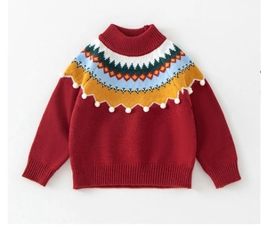 Detail of red knit sweater featuring colorful geometric patterns and white pom-pom trim