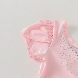 Detail of pink girls ballet leotard with sparkling rhinestones and ruffled sleeves