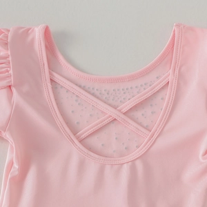 Pink ballet leotard featuring V-back with cross straps and polka dot mesh detailing